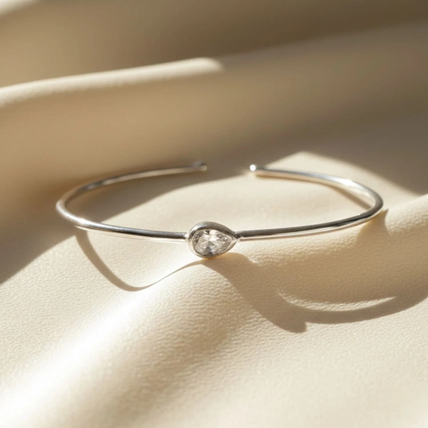 Minimalist white topaz April birthstone bangle bracelet in rhodium plated sterling silver