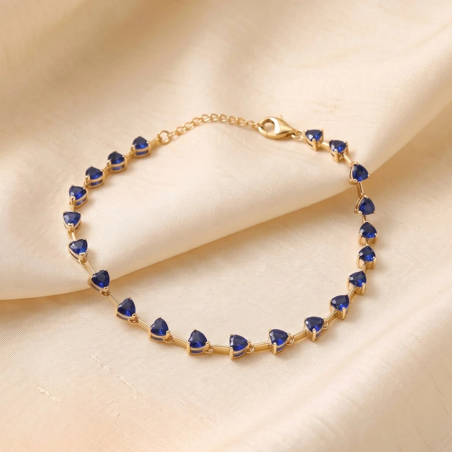 Gold plated heart tennis bracelet set with blue sapphire birthstones