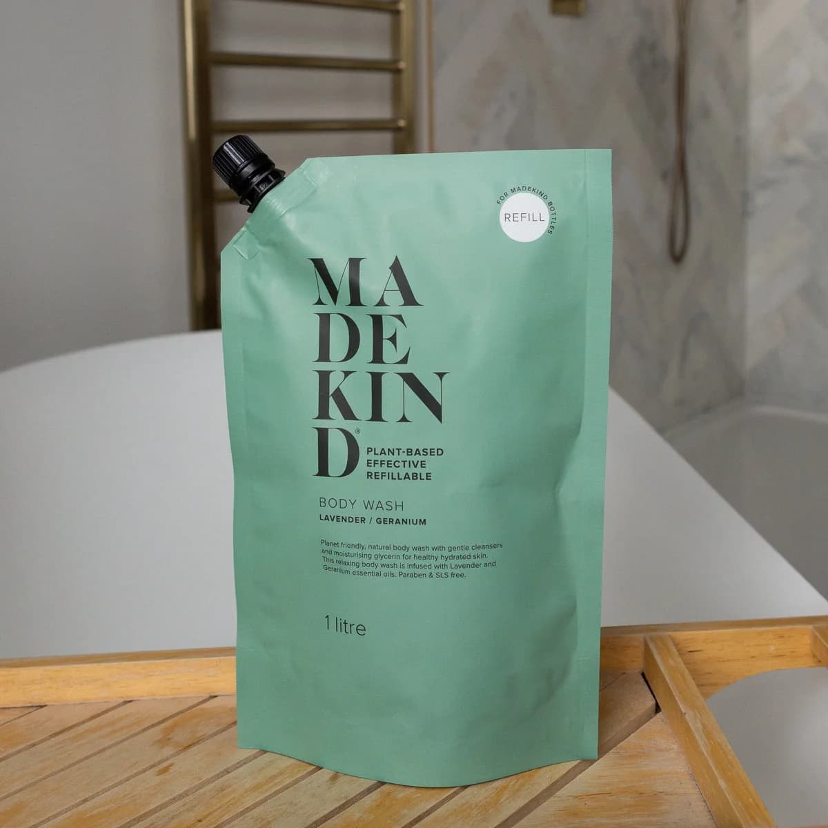 MadeKind Body Wash Refill Pouch on a bath tidy across a bath