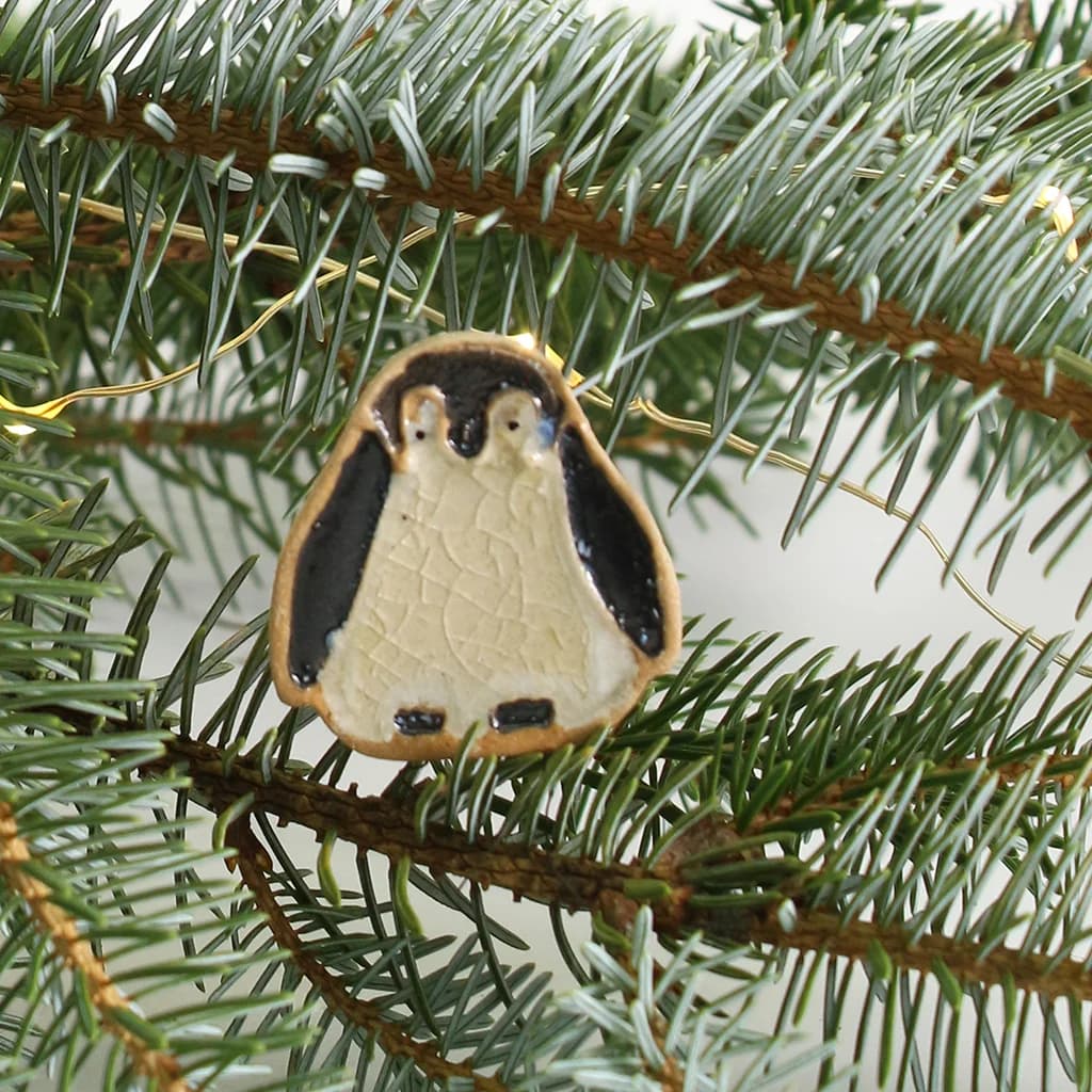 Penguin ornament on a Christmas tree branch