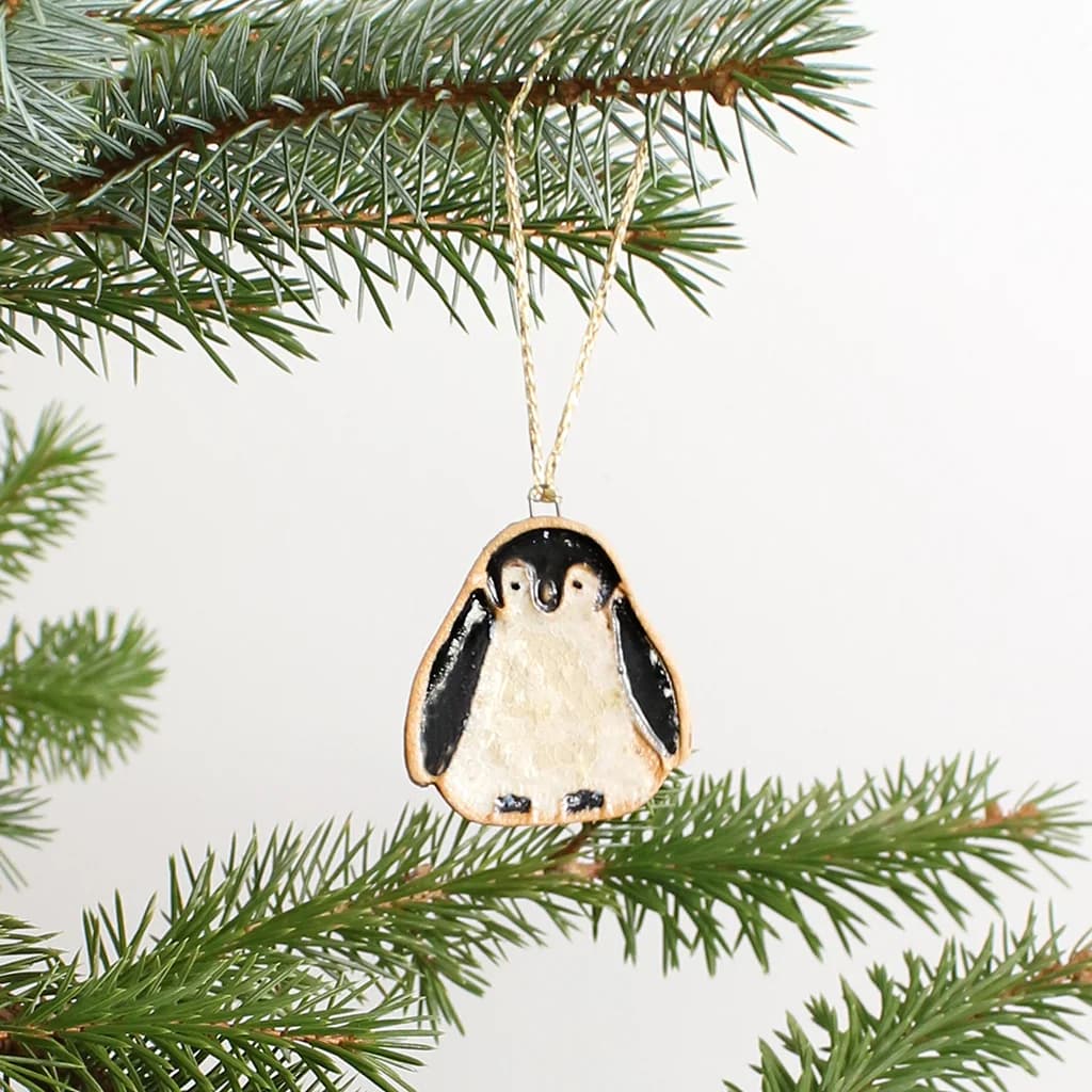 Ceramic Penguin Christmas ornament hanging on a tree branch